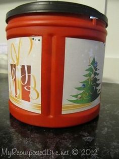 a red plastic container sitting on top of a counter next to a black countertop