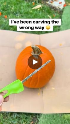 someone is carving the wrong way with a green handled knife on top of a pumpkin