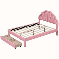 a pink bed with two drawers underneath it