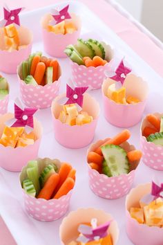 a table topped with cups filled with different types of food