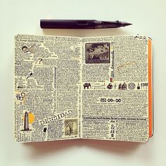 an open book with some pictures on it and a pen resting on top of it