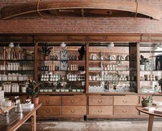 the inside of a store with lots of bottles and shelves filled with goods on display