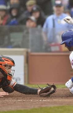 a baseball player sliding into home plate during a game