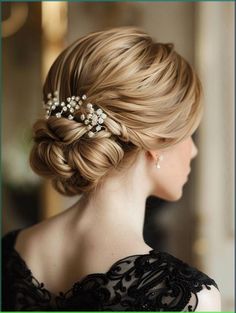 a woman with blonde hair wearing a wedding hairstyle and pearls in her hair is looking off to the side