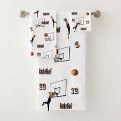 two towels with basketballs on them hanging from a towel rack in front of a white wall