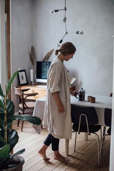 a woman standing in front of a table