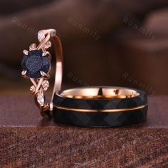 two wedding rings with black diamonds on them