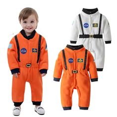 two children's jumpsuits with nasa patches on them, one in orange and the other in white