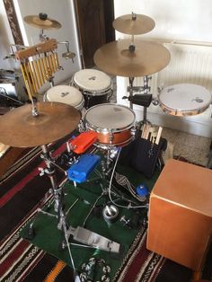 a drum set sitting on top of a rug