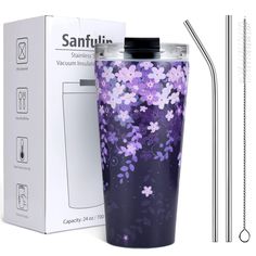 a purple flowered tumbler next to a box with a straw