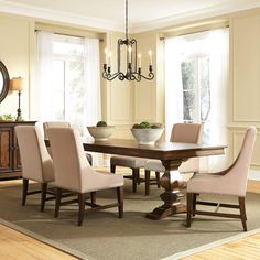 a dinning room table with chairs around it