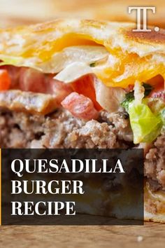 a close up of a sandwich on a wooden table with the words quesadilla burger recipe