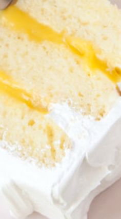 a piece of cake with white frosting and yellow icing