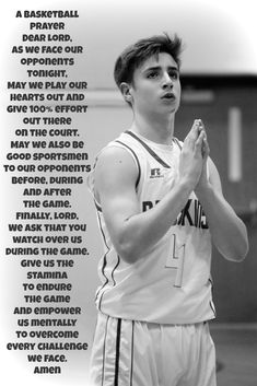 a young man standing on top of a basketball court with his hands in the air