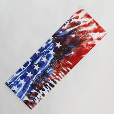 an american flag is painted on the side of a piece of paper with red, white and blue colors