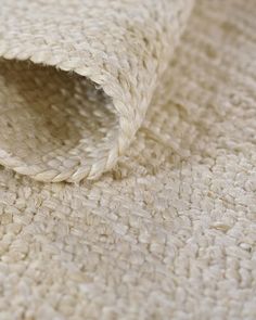 a close up view of a white rug with some sort of woven material on it