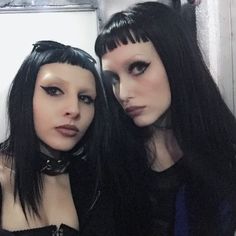 two women with black hair are posing for the camera