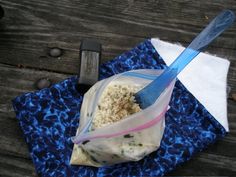 a blue and white cloth with a plastic bag on top of it next to a knife