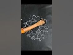 a child is drawing on a blackboard with chalk