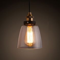 a light bulb hanging from the ceiling in a room with dark walls and flooring