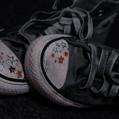 two pairs of shoes with stars painted on them