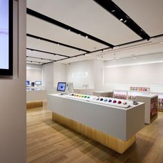 an empty store with lots of items on the counter and in front of it is a flat screen tv