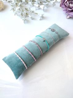 These pillows, which are completely handmade, are carefully sewn in a part of my house that I turn into a workshop. These pillows, where you will display your jewellery, bracelets, watches, buckles and other accessories in a stylish way, are securely sewn using a velvet fabric that you can use for many years. Pillows are filled with poly-fil filling. I overfill it to get as much fullness as you need. Thanks to the envelope flap design on the back of this pillow, it will provide the ability to remove some of it when needed. **Dimensions** 3.1''x7,8'' inc - (8x20 cm) 3.1''x9,8'' inc - (8x25 cm) 3.5''x8.5'' inc - (8.9x21.6 cm) Custom Size (up to 10" inc-25.4 cm) Oval, cylindrical, rectangular etc. shapes and linen, silky satin, satin, jute, faux leather, suede, velvet, cotton etc. I can produ Bracelet Pillow, Bracelet Organizer, Jewellery Bracelets, Bracelets Jewelry, Jewelry Display, Jewelry Holder, Jewellery Display, My House, Jewelry Organization