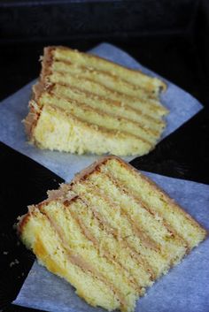 two slices of yellow cake sitting on top of napkins in front of each other