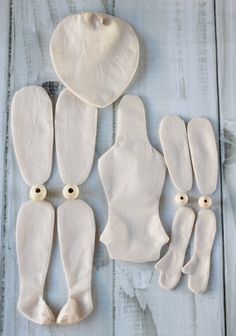 several pieces of white clay sitting on top of a wooden table