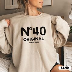 Looking for a unique and personal 40th birthday gift? Look no further than this cute No 40 Original sweatshirt! It's the perfect way to show your loved one how much you care on their special day. Not only is it stylish, but it also makes a great gift for her birthday or any other special occasion.  * Q U I C K * F A C T S * ✺ 50% cotton, 50% polyester ✺ Medium-heavy fabric ✺ Wash and dry normally (on cool for best results) ✺ Product color may slightly vary due to photographic lighting sources or Funny 40th Shirts, 45th Birthday Shirt Ideas For Women, Funny 50 Year Old Shirts, Big 40 Birthday Ideas For Women, 40th Birthday Sweatshirt, Birthday Sweatshirt Ideas, 40tg Birthday Ideas For Women, 40th Birthday Tshirts Woman, Birthday 40 Woman