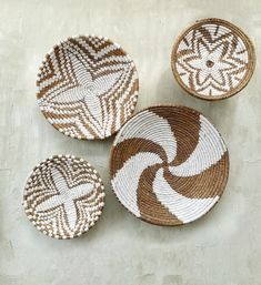 three brown and white baskets sitting on top of a table next to each other,