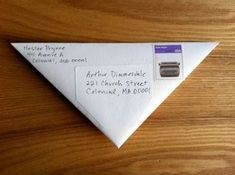 an origami paper triangle with writing on it