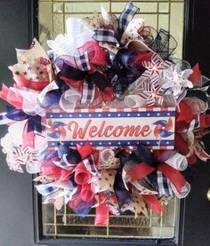 Patriotic Pinwheel wreath Approximately 26 inches across, this wreath features a pinwheel Welcome sign, mini pinwheels and a variety of red, white, and blue ribbons.  A red, white and blue Crafting mesh base accented with curls & ruffles, this wreath is ready to adorn your door this summer! Please note:  Crafting mesh and burlap are prone to fraying.   While I make every effort to trim all loose strings prior to shipping, some additional trimming may be necessary Wreaths are packed tightly to help protect during shipping and may require some fluffing upon arrival Ruffle And Curl Wreath, Pinwheels Wreath, Mini Pinwheels, Pinwheel Wreath, Door Wreath Hanger, Blue Ribbon, Red White And Blue, Door Hangers, Door Wreaths