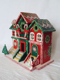 a red and green christmas house on a white background