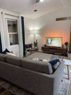 a living room filled with furniture and a flat screen tv