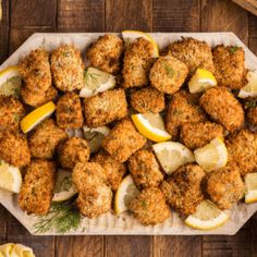 chicken nuggets with lemon wedges and dill pickles