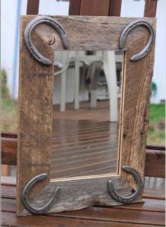 an old wooden frame with metal handles on the outside of it is sitting on a bench