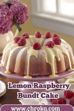 a lemon raspberry bundt cake with icing and fresh raspberries