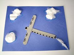 an airplane made out of paper with clouds