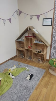 there is a dog house made out of pallets and other things on the floor