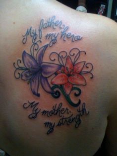 the back of a woman's shoulder with flowers and words written in cursive writing