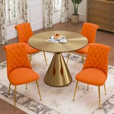 an orange and gold dining table with six chairs around it in front of a window