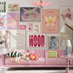 a living room filled with pink furniture and lots of pictures on the wall above it