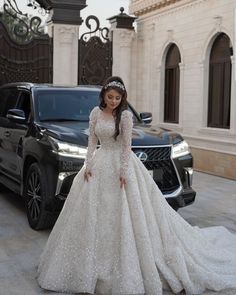 a woman in a wedding dress standing next to a car