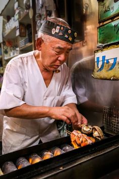 a man cooking food on top of a grill