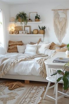 a white bedroom with lots of plants on the shelves above the bed and in front of the window