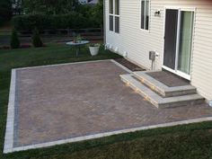 a brick patio with steps leading up to it