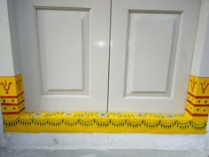 the front door is decorated with yellow and red designs