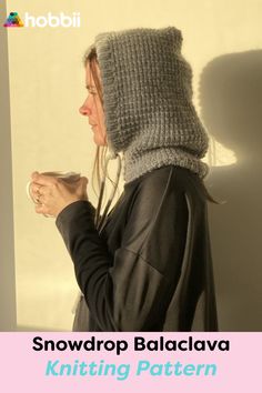 a woman wearing a knitted hat and holding a cup in her hands with the words snowdrop balaclava knitting pattern on it