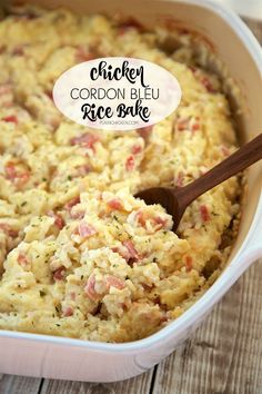 chicken cordon bleu rice bake in a casserole dish with a wooden spoon